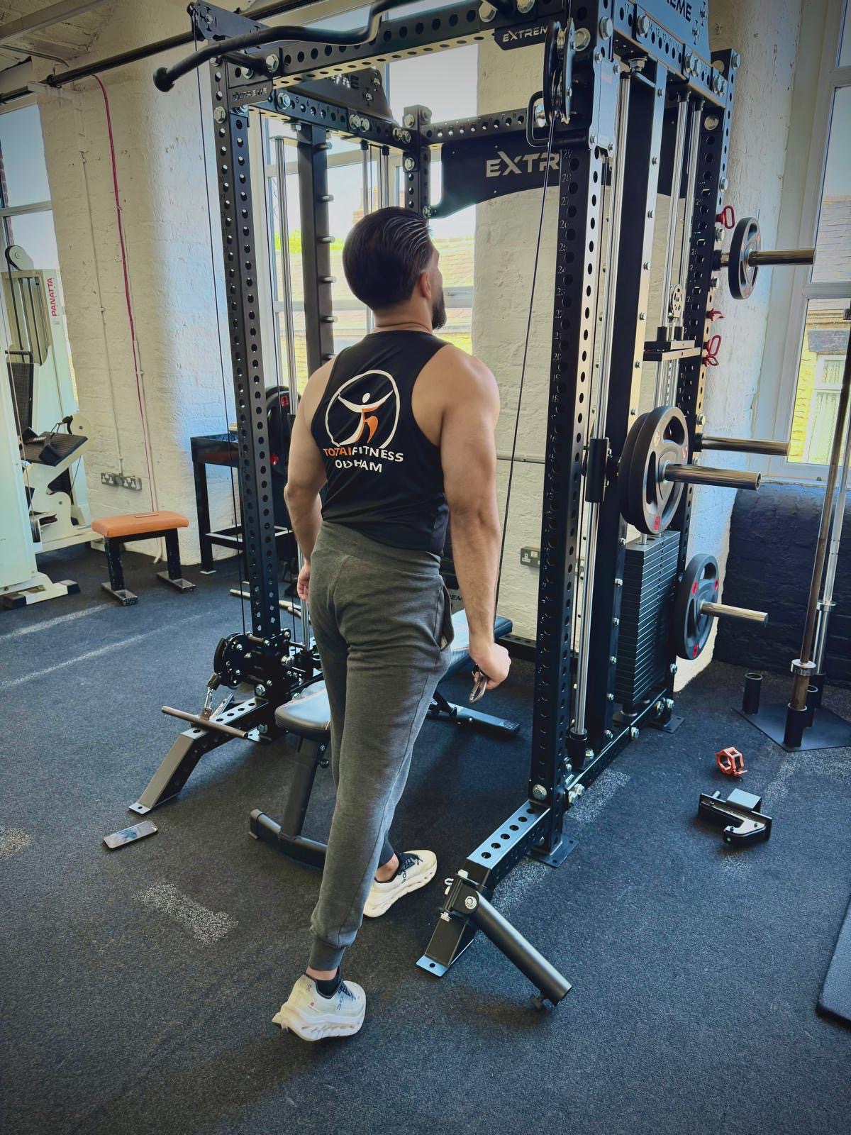 Member wearing official Total Fitness Oldham vest in the gym