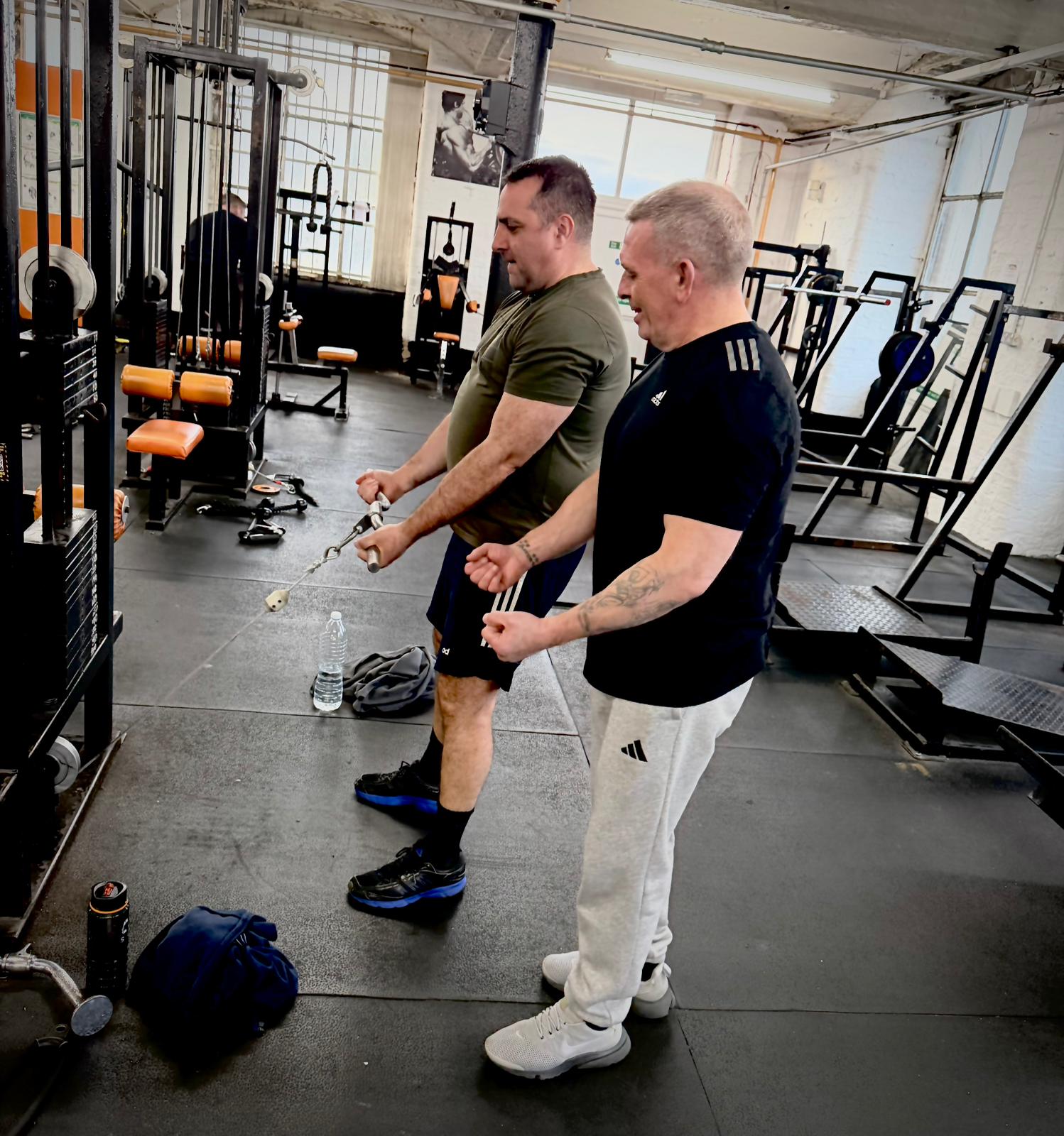 Members training together on cable machines
