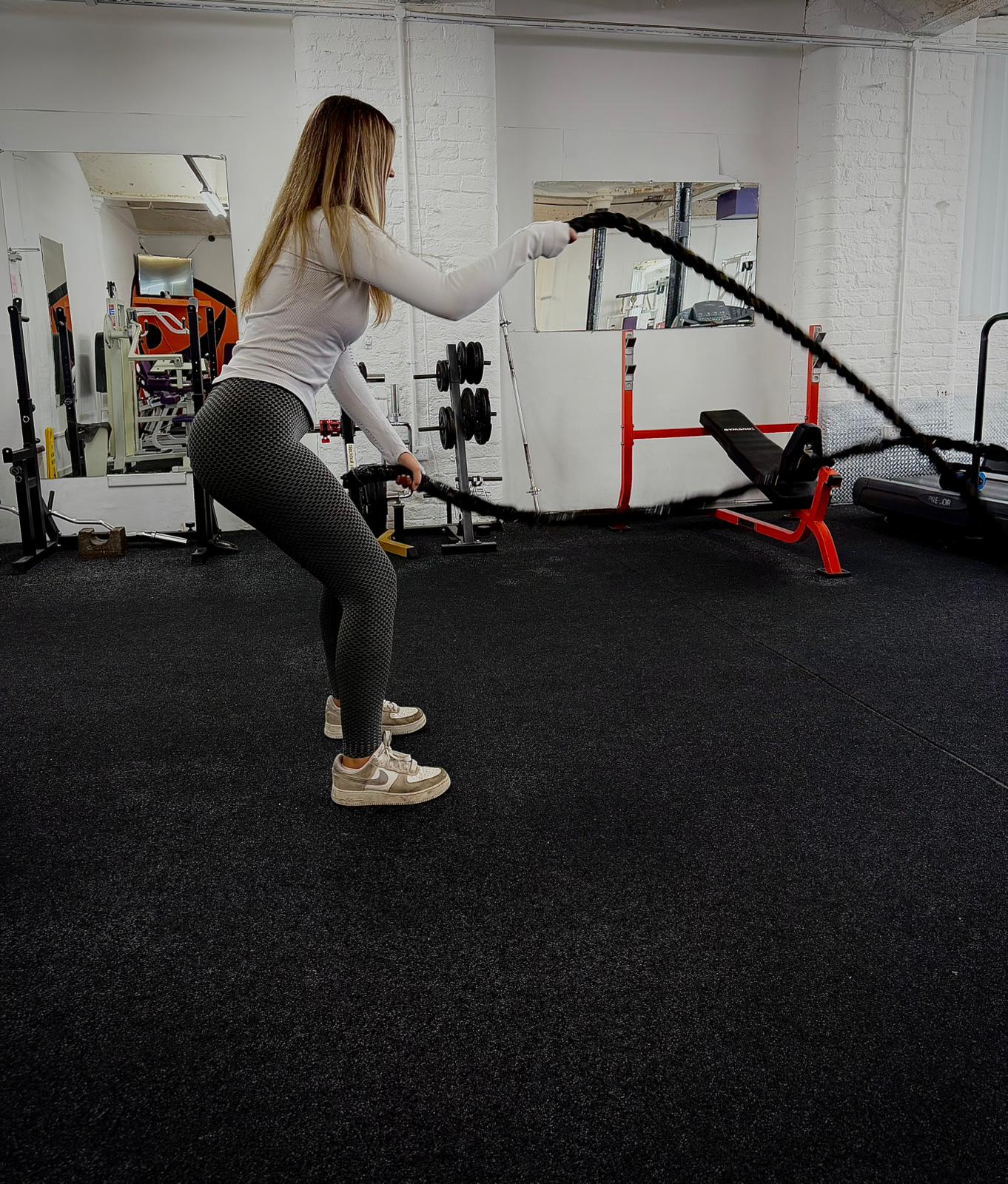 Member doing battle ropes in the women's only section